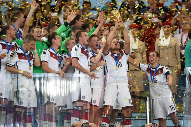 July 13, 2014; Rio de Janeiro, BRAZIL; Germany forward Lukas Podolski (10) celebrates with the world cup trophy after the championship match of the 2014 World Cup against the Argentina at Maracana Stadium. Germany won 1-0.  Mandatory Credit: Tim Groothuis/Witters Sport via USA TODAY Sports
