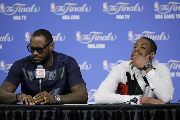 Miami Heat forward LeBron James, left, and Dwyane Wade participate in a news conference after Game 5 of the NBA basketball finals against the San Antonio Spurs, on Sunday, June 15, 2014, in San Antonio. The Spurs won the NBA championship 104-87. (AP Photo/Tony Gutierrez)