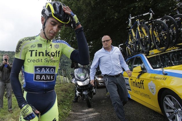 Spain's Alberto Contador holds his head prior to abandoning race following a crash during the tenth stage of the Tour de France cycling race over 161.5 kilometers (100.4 miles) with start in Mulhouse and finish in La Planche des Belles Filles, France, Monday, July 14, 2014. (AP Photo/Christophe Ena)