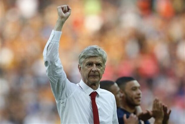 FILE - In this Saturday, May 17, 2014 file photo, Arsenal's manager Arsene Wenger punches the air in celebration of their win against Hull City at the end of their English FA Cup final soccer match at Wembley Stadium in London. Arsenal manager Arsene Wenger has signed a three-year deal with the Premier League club, keeping him at the Emirates Stadium until 2017. The new deal was announced by Arsenal on Friday and will take Wenger into his 21st year at the club, where he has been in charge since 1996. The 64-year-old Frenchman won three Premier League titles and four FA Cups in the first half of his Arsenal tenure, but failed to capture a trophy in nine years until winning this season's FA Cup. Wenger has guided the London side into the Champions League for 17 consecutive seasons and is the longest-serving manager in the Premier League. (AP Photo/Sang Tan, file) FILE - In this Saturday, May 17, 2014 file photo, Arsenal's manager Arsene Wenger punches the air in celebration of their win against Hull City at the end of their English FA Cup final soccer match at Wembley Stadium in London. Arsenal manager Arsene Wenger has signed a three-year deal with the Premier League club, keeping him at the Emirates Stadium until 2017. The new deal was announced by Arsenal on Friday and will take Wenger into his 21st year at the club, where he has been in charge since 1996. The 64-year-old Frenchman won three Premier League titles and four FA Cups in the first half of his Arsenal tenure, but failed to capture a trophy in nine years until winning this season's FA Cup. Wenger has guided the London side into the Champions League for 17 consecutive seasons and is the longest-serving manager in the Premier League. (AP Photo/Sang Tan, file)