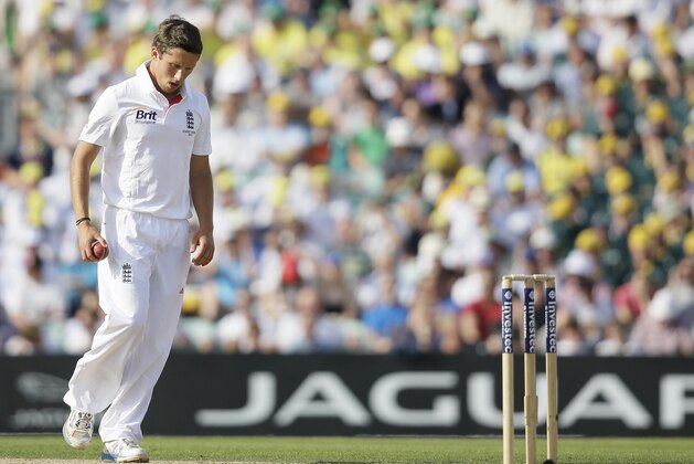 England's Simon Kerrigan returns to his mark to bowl to Australia's Steven Smith, unseen, during play on the first day of the fifth Ashes cricket Test at the Oval cricket ground in London, Wednesday, Aug.  21, 2013.  (AP Photo/Alastair Grant)