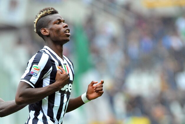 Juventus midfielder Paul Pogba of France celebrates after scoring, during a Serie A soccer match between Torino and Juventus, at the Olympic stadium, in Turin, Italy, Sunday, Sept. 29, 2013. (AP Photo/Massimo Pinca)