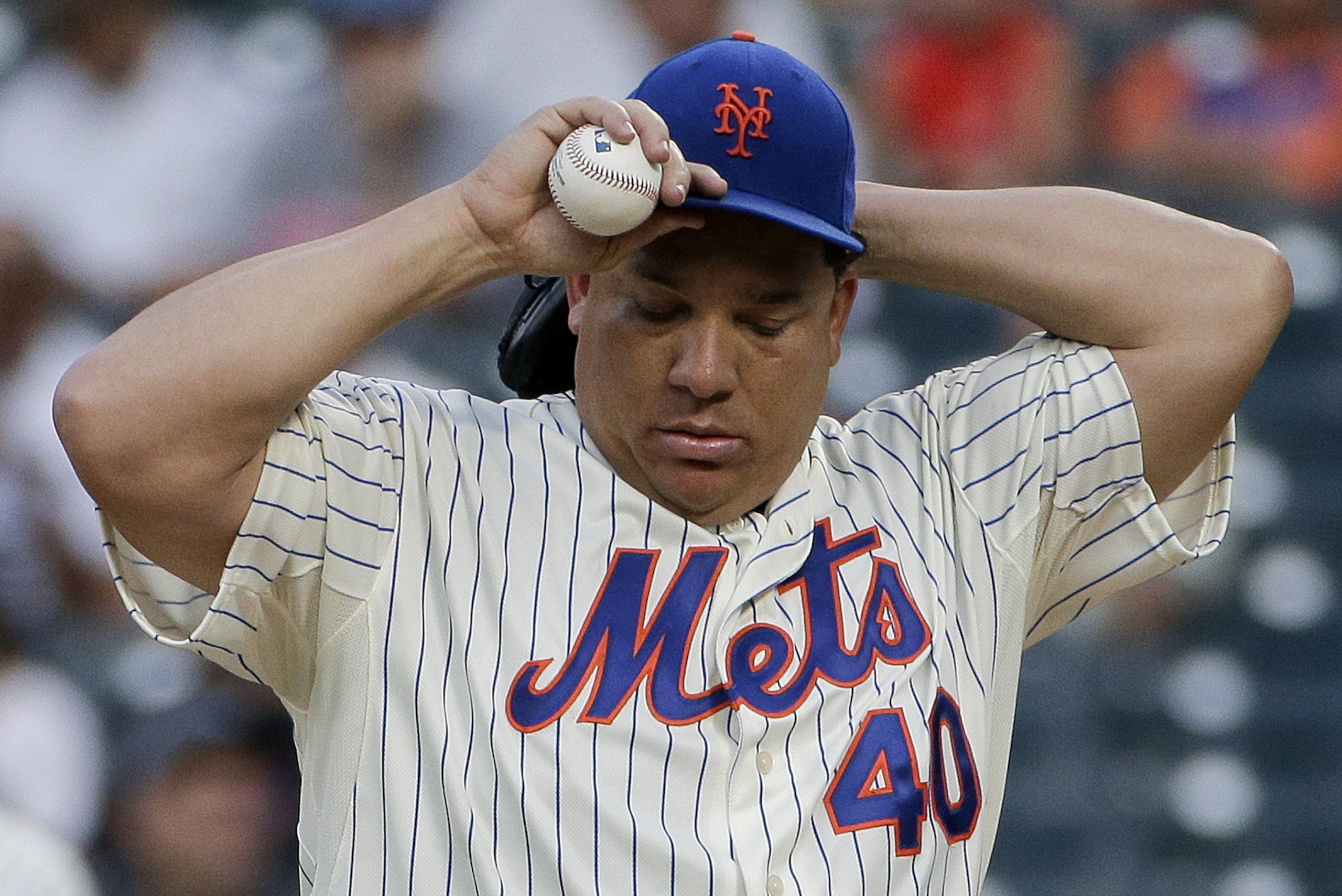 New York Mets pitcher Bartolo Colon (40) adjusts his cap before pitching against the Atlanta Braves in the second inning of a baseball game, Thursday, July 10, 2014, in New York. (AP Photo/Julie Jacobson)