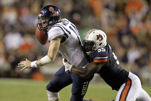 Oct 5, 2013; Auburn, AL, USA; Mississippi Rebels quarterback Bo Wallace (14) is tackled by Auburn Tigers defensive end Carl Lawson (55) during the first half at Jordan Hare Stadium. Mandatory Credit: John Reed-USA TODAY Sports