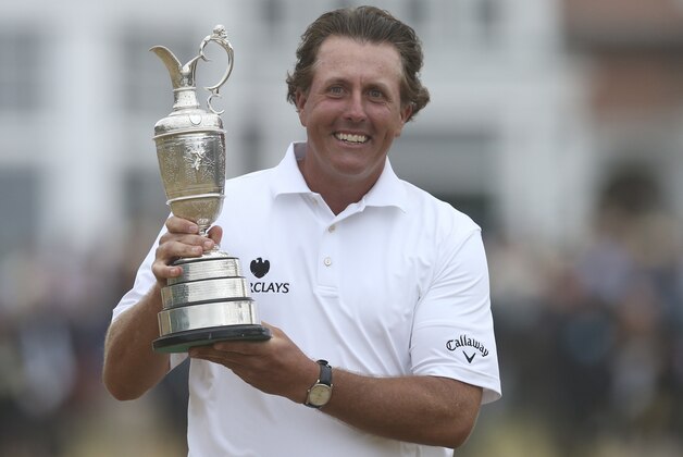 Phil Mickelson of the United States holds up the Claret Jug trophy after winning the British Open Golf Championship at Muirfield, Scotland, Sunday July 21, 2013.  (AP Photo/Scott Heppell)