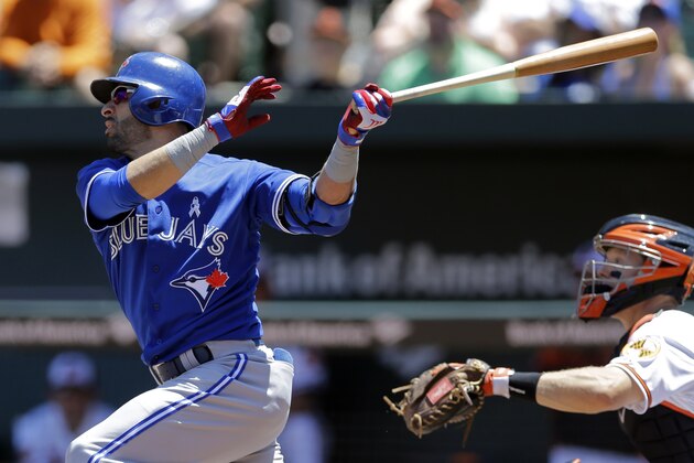 Toronto Blue Jays' Jose Bautista, left, watches his double in the first inning of a baseball game against the Baltimore Orioles, Sunday, June 15, 2014, in Baltimore. Blue Jays' Jose Reyes scored on the play. (AP Photo/Patrick Semansky)