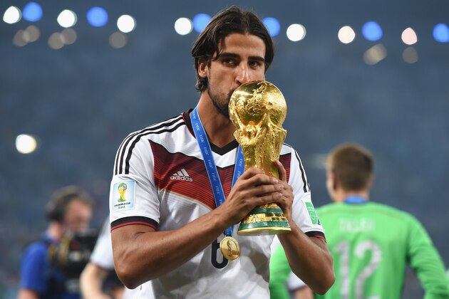 RIO DE JANEIRO, BRAZIL - JULY 13:  Sami Khedira of Germany kisses the World Cup trophy  after defeating Argentina 1-0 in extra time during the 2014 FIFA World Cup Brazil Final match between Germany and Argentina at Maracana on July 13, 2014 in Rio de Janeiro, Brazil.  (Photo by Matthias Hangst/Getty Images)