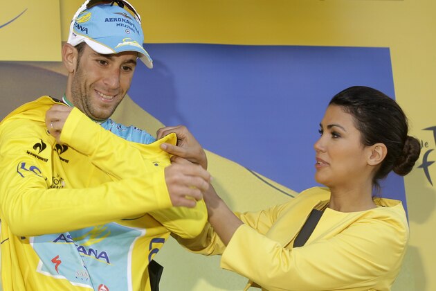Italy's Vincenzo Nibali, puts on the overall leader's yellow jersey, celebrates on the podium of the tenth stage of the Tour de France cycling race over 161.5 kilometers (100.4 miles) with start in Mulhouse and finish in La Planche des Belles Filles, France, Monday, July 14, 2014. (AP Photo/Laurent Cipriani)