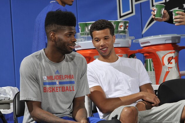 ORLANDO, FL - JULY 11: Nerlens Noel #4 and Michael Carter-Williams #1 of the Philadelphia 76ers sit on the sideline during a game against the Memphis Grizzlies on July 11, 2014 at Amway Center in Orlando, Florida. NOTE TO USER: User expressly acknowledges and agrees that, by downloading and or using this photograph, User is consenting to the terms and conditions of the Getty Images License Agreement. Mandatory Copyright Notice: Copyright 2014 NBAE  (Photo by Fernando Medina/NBAE via Getty Images)