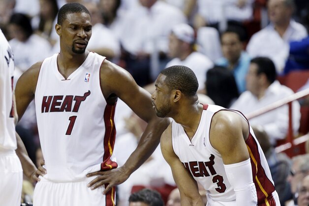 Miami Heat center Chris Bosh (1) and guard Dwyane Wade (3) talk as they fall behind the Indiana Pacers during the first half of Game 3 in the NBA basketball Eastern Conference finals playoff series, Saturday, May 24, 2014, in Miami. (AP Photo/Lynne Sladky)