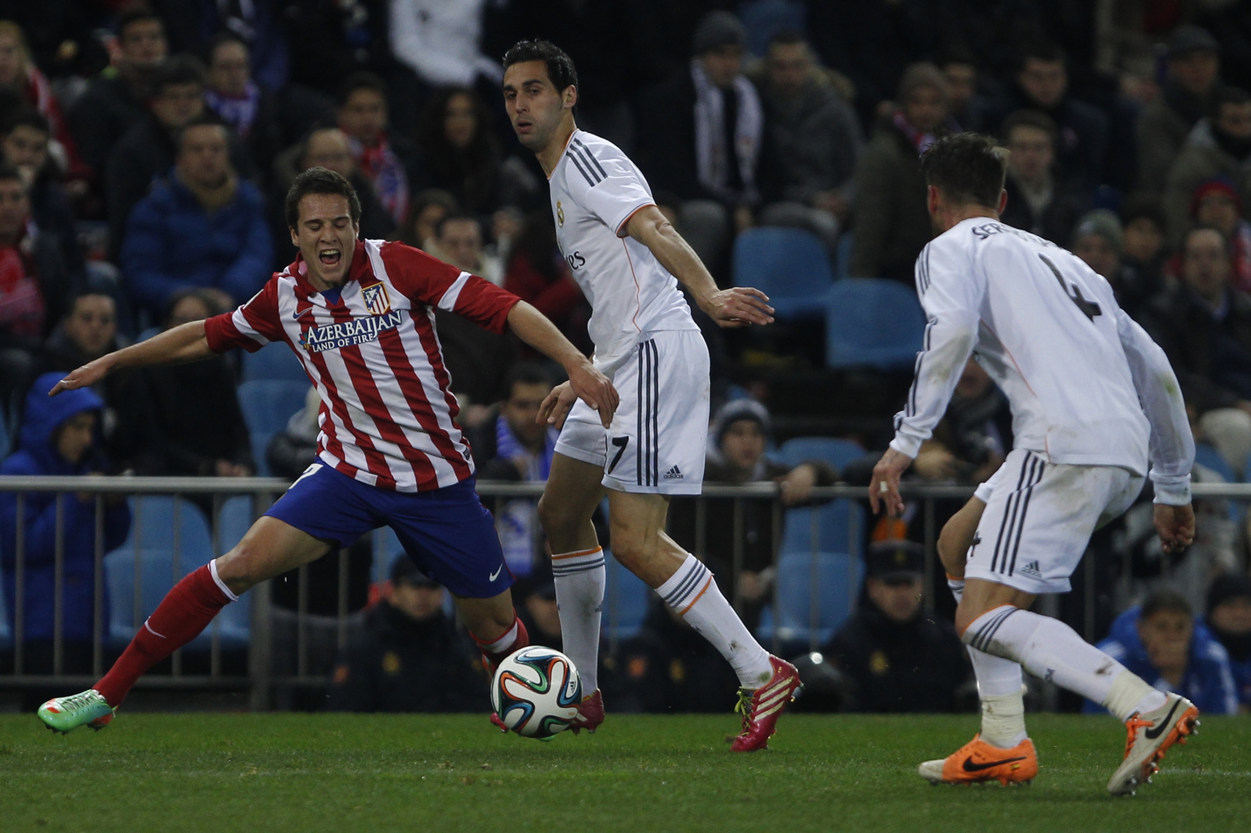 Atletico's Javi Manquillo in action with Real's Alvaro Arbeloa during a semi final, 2nd leg, Copa del Rey soccer derby match between Real Madrid and Atletico Madrid at the Vicente Calderon Stadium in Madrid, Tuesday Feb. 11 , 2014.  (AP Photo/Gabriel Pecot)