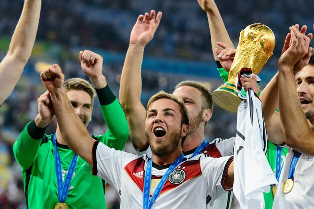 RIO DE JANEIRO, BRAZIL - JULY 13: Mario Goetze celebrate with the World Cup trophy after defeating Argentina 1-0 in extra time during the 2014 FIFA World Cup Brazil Final match between Germany and Argentina at Maracana on July 13, 2014 in Rio de Janeiro, Brazil.  (Photo by Matthias Hangst/Getty Images)