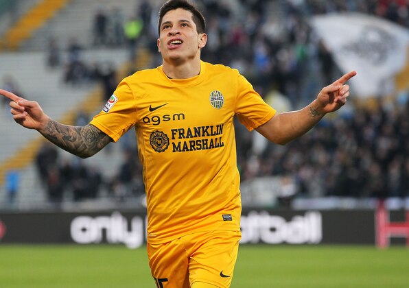Verona's Juan Manuel Iturbe  celebrates after scoring, during a Serie A soccer match between Udinese and Verona at the Friuli Stadium in Udine, Italy, Monday, Jan. 6, 2014. (AP Photo/Paolo Giovannini)