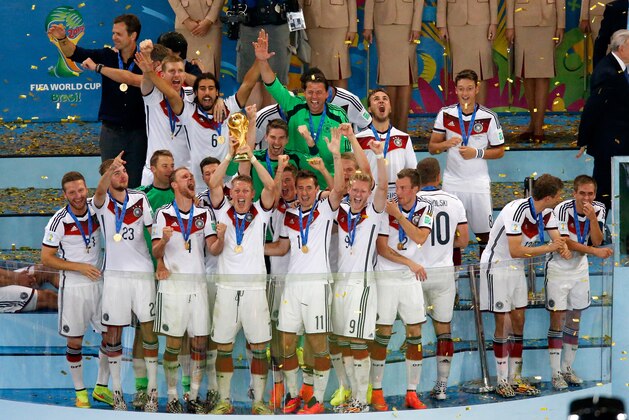 RIO DE JANEIRO, BRAZIL - JULY 13:  Bastian Schweinsteiger of Germany raises the World Cup trophy in celebration with his teammates after defeating Argentina 1-0 in extra time during the 2014 FIFA World Cup Brazil Final match between Germany and Argentina at Maracana on July 13, 2014 in Rio de Janeiro, Brazil.  (Photo by Fabrizio Bensch - Pool/Getty Images)