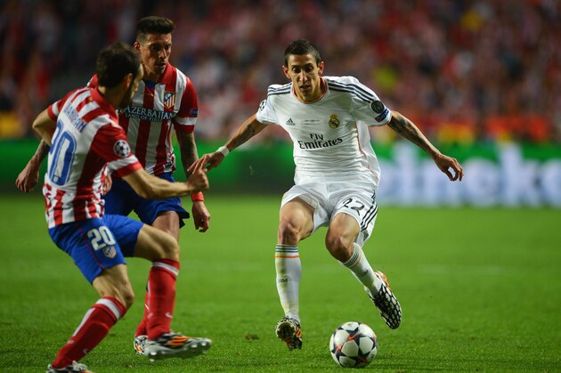 LISBON, PORTUGAL - MAY 24:  Angel Di Maria of Real Madrid takes on Juanfran (L) and Jose Sosa of Club Atletico de Madrid (C) during the UEFA Champions League Final between Real Madrid and Atletico de Madrid at Estadio da Luz on May 24, 2014 in Lisbon, Portugal.  (Photo by Michael Regan/Getty Images)