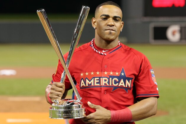 Jul 14, 2014; Minneapolis, MN, USA; American League outfielder Yoenis Cespedes (52) of the Oakland Athletics hoists the championship trophy after winning the 2014 Home Run Derby the day before the MLB All Star Game at Target Field. Mandatory Credit: Jesse Johnson-USA TODAY Sports