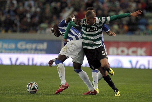 Sporting's Islam Slimani, right, from Algeria, battles for the ball with Porto's Eliaquim Mangala, from France, during the Portuguese league soccer match between Sporting and Porto at Sporting's Alvalade stadium, in Lisbon, Sunday, March 16, 2014. (AP Photo/Francisco Seco)