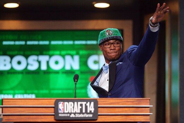 Jun 26, 2014; Brooklyn, NY, USA; Marcus Smart (Oklahoma State) waves to the crowd as he leaves the stage after being selected as the number six overall pick to the Boston Celtics in the 2014 NBA Draft at the Barclays Center. Mandatory Credit: Brad Penner-USA TODAY Sports
