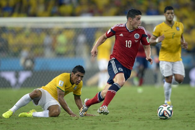 Colombia's James Rodriguez, right, gets away from Brazil's Paulinho during the World Cup quarterfinal soccer match between Brazil and Colombia at the Arena Castelao in Fortaleza, Brazil, Friday, July 4, 2014. (AP Photo/Manu Fernandez)