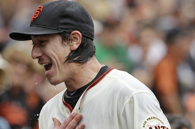 San Francisco Giants pitcher Tim Lincecum heads for the dugout after being doused by his teammates following his no-hitter against the San Diego Padres in a baseball game Wednesday, June 25, 2014, in San Francisco. Lincecum threw his second career no-hitter as San Francisco won 4-0. (AP Photo/Eric Risberg)
