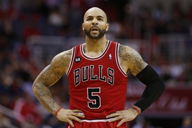 Chicago Bulls forward Carlos Boozer (5) stands on the court during a break in the action during the first half of Game 4 of an opening-round NBA basketball playoff series against the Washington Wizards in Washington, Sunday, April 27, 2014. (AP Photo/Alex Brandon)