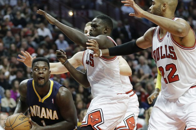 Indiana Pacers guard Lance Stephenson (1), left, looks to pass as Chicago Bulls' Luol Deng (9), Erik Murphy (31) and Taj Gibson (22) guard during the second half of an NBA preseason basketball game in Chicago on Friday, Oct. 18, 2013. The Bulls won 103-98. (AP Photo/Nam Y. Huh)