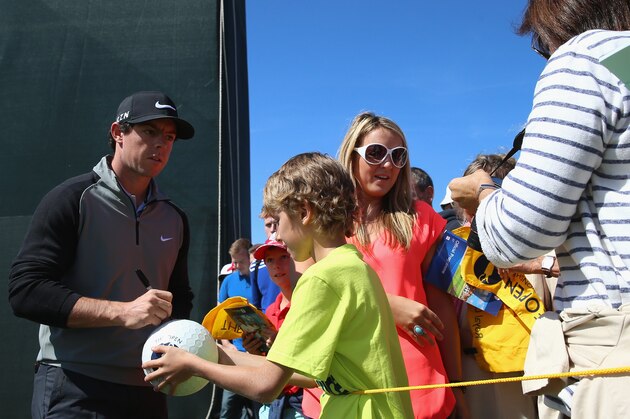 HOYLAKE, ENGLAND - JULY 15:  Rory McIlroy of Northern Ireland signs autographs for fans during a practice round prior to the start of The 143rd Open Championship at Royal Liverpool on July 15, 2014 in Hoylake, England.  (Photo by Andrew Redington/Getty Images)