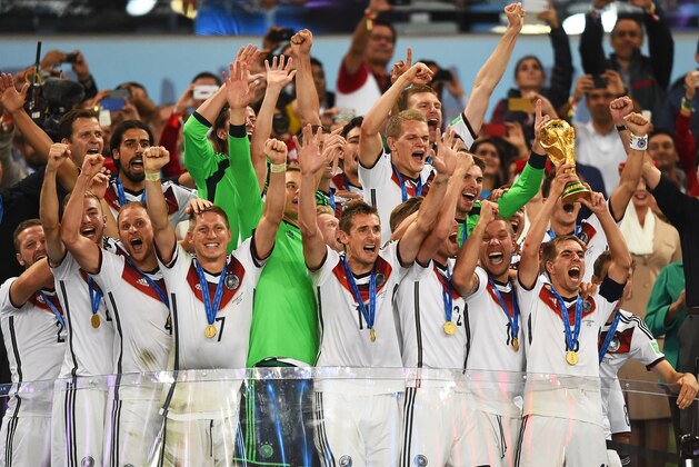 RIO DE JANEIRO, BRAZIL - JULY 13:  Philipp Lahm of Germany raises the World Cup trophy with teammates after defeating Argentina 1-0 in  the 2014 FIFA World Cup Brazil Final match between Germany and Argentina at Maracana on July 13, 2014 in Rio de Janeiro, Brazil.  (Photo by Laurence Griffiths/Getty Images)