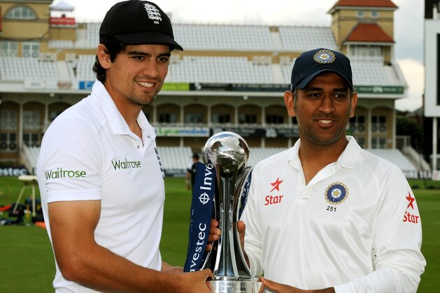 England captain Alastair Cook. left, and India captain M.S. Dhoni pose with the Trophy during a photocall ahead of  the first Test Match between England and India at Trent Bridge cricket ground, Nottingham, England, Tuesday, July 8, 2014. England start the first Test Match against India at Trent Bridge on Wednesday July 9 2014. (AP Photo/Rui Vieira)