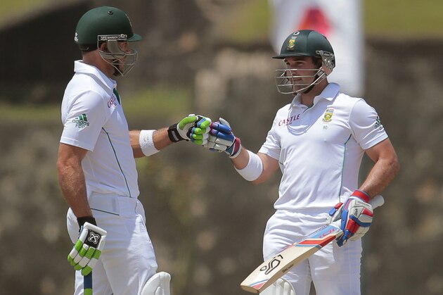 South African batsman  Dean Elgar celebrates scoring a half century with Faf du Plessis during the first day of the first test cricket match between Sri Lanka and South Africa in Galle, Sri Lanka, Wednesday, July 16, 2014. (AP Photo/Eranga Jayawardena)