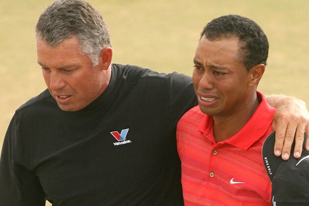 Tiger Woods of the  United States, right, reacts as he walks off the 18th green with his caddie Steve Williams after winning the British Open Golf Championship at the Royal Liverpool Golf Course in Hoylake, England Sunday July 23, 2006. (AP Photo/Alessia Pierdomenico)
