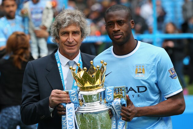 MANCHESTER, ENGLAND - MAY 11:  The Manchester City Manager Manuel Pellegrini and Yaya Toure pose with the trophy at the end of the Barclays Premier League match between Manchester City and West Ham United at the Etihad Stadium on May 11, 2014 in Manchester, England.  (Photo by Alex Livesey/Getty Images)