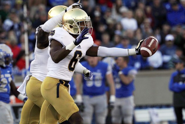Notre Dame cornerback KeiVarae Russell, front, celebrates after recovering a fumble to stall a drive by Air Force in the second quarter of an NCAA college football game in Air Force Academy, Colo., Saturday, Oct. 26, 2013. (AP Photo/David Zalubowski)