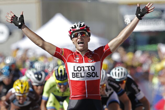 France's Tony Gallopin manages to stay ahead of the sprinting pack, rear, as he crosses the finish line to win the eleventh stage of the Tour de France cycling race over 187.5 kilometers (116.5 miles) with start in Besancon and finish in Oyonnax, France, Wednesday, July 16, 2014. (AP Photo/Peter Dejong)