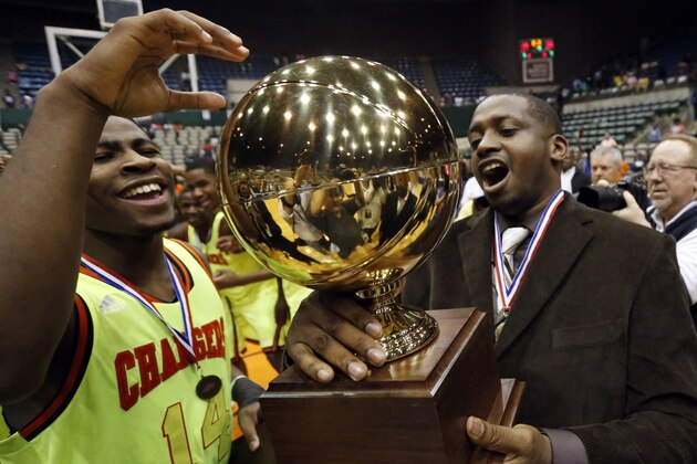 Callaway guard Malik Newman (14) and coach David Sanders hold the trophy as they celebrate Callaway's 49-33 win over Vicksburg in the MHSAA boys' Class 5A championship basketball game in Jackson, Miss., Friday, March 14, 2014. (AP Photo/Rogelio V. Solis)