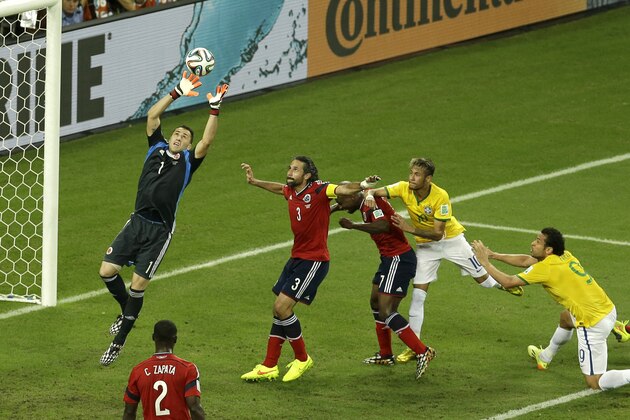 Colombia's goalkeeper David Ospina, left, catches a ball as Brazil's Neymar, second from right, and Fred, right, approach the goal during the World Cup quarterfinal soccer match between Brazil and Colombia at the Arena Castelao in Fortaleza, Brazil, Friday, July 4, 2014. (AP Photo/Themba Hadebe)