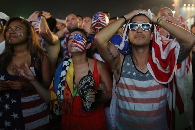 Fans of the United States national soccer team react, in frustration, as they watch their team's World Cup round of 16 match against Belgium on a live telecast inside the FIFA Fan Fest area on Copacabana beach in Rio de Janeiro, Brazil, Tuesday, July 1, 2014. Belgium beat the United States 2-1 in extra time to reach World Cup quarterfinals. (AP Photo/Leo Correa)