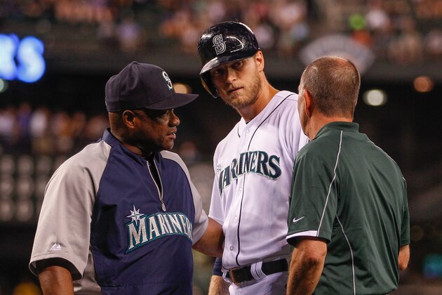 SEATTLE, WA - JULY 10:  Michael Saunders #55 of the Seattle Mariners is removed from the game by manager Lloyd McClendon #23 (L) due to an apparent injury during an at-bat in the eighth inning against the Minnesota Twins at Safeco Field on July 10, 2014 in Seattle, Washington. Trainer Rick Griffin is at right.  (Photo by Otto Greule Jr/Getty Images)