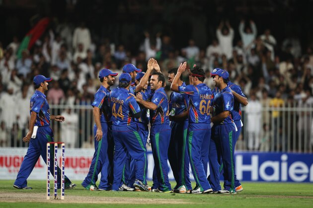 SHARJAH, UNITED ARAB EMIRATES - DECEMBER 08: Afghanistan celebrate during the Twenty20 match between Afghanistan and Pakistan at the Sharjah Cricket Stadium on December 8, 2013 in Sharjah, United Arab Emirates.  (Photo by Francois Nel/Getty Images)