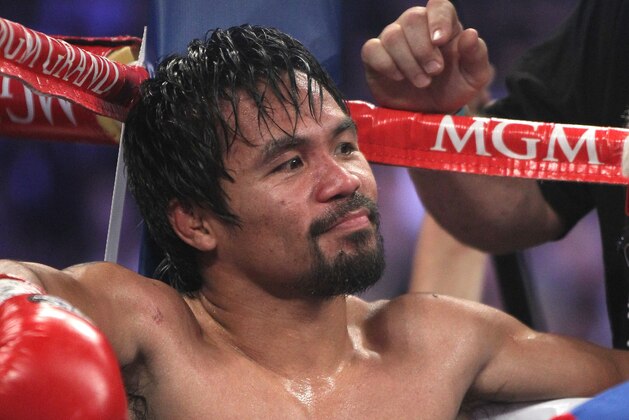 Manny Pacquiao, of the Philippines, sits in his corner between rounds of his WBO welterweight title boxing fight against Timothy Bradley Saturday, April 12, 2014, in Las Vegas. (AP Photo/Isaac Brekken)