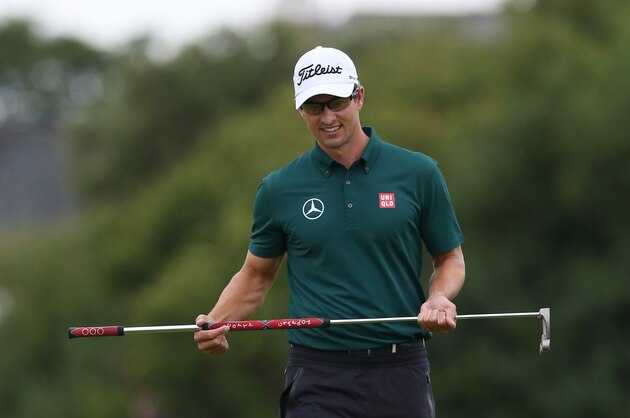 Adam Scott of Australia holds his putter on the 2nd green during a practice round ahead of the British Open Golf championship at the Royal Liverpool golf club, Hoylake, England, Wednesday July 16, 2014. The British Open Golf championship starts Thursday July 17. (AP Photo/Jon Super)
