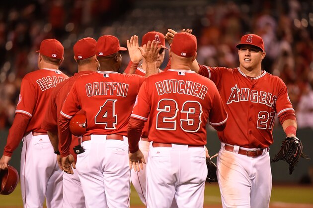 ANAHEIM, CA - JUNE 25:  Mike Trout #27 of the Los Angeles Angels of Anaheim celebrates with his teammates after defeating the Minnesota Twins 6-2 at Angel Stadium of Anaheim on June 25, 2014 in Anaheim, California.  (Photo by Lisa Blumenfeld/Getty Images)