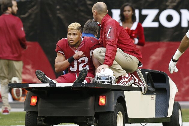 An injured Arizona Cardinals' Tyrann Mathieu (32) leaves the field during the second half of an NFL football game against the St. Louis Rams Sunday, Dec. 8, 2013, in Glendale, Ariz.  The Cardinals defeated the Rams 30-10. (AP Photo/Ross D. Franklin)