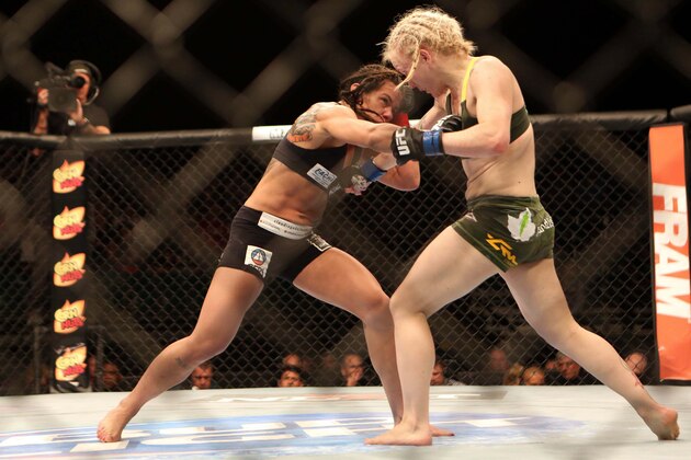 Jul 16, 2014; Atlantic City, NJ, USA; Claudia Gadelha (red gloves) exchanges punches with Tina Lahdemaki (blue gloves) during a 115-pound women's division bout at Revel Casino. Mandatory Credit: Bill Streicher-USA TODAY Sports Jul 16, 2014; Atlantic City, NJ, USA; Claudia Gadelha (red gloves) exchanges punches with Tina Lahdemaki (blue gloves) during a 115-pound women's division bout at Revel Casino. Mandatory Credit: Bill Streicher-USA TODAY Sports