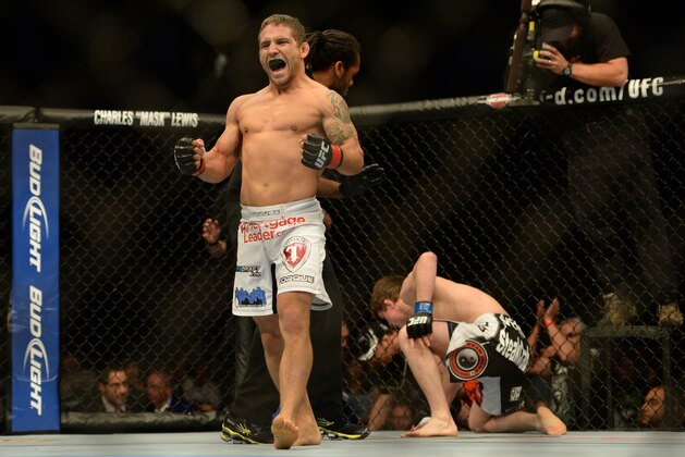 Apr 20, 2013; San Jose, CA, USA; Chad Mendes (left) celebrates after defeating Darren Elkins (right) during the featherweight bout prelims of the UFC on Fuel TV at HP Pavilion. Mandatory Credit: Kyle Terada-USA TODAY Sports