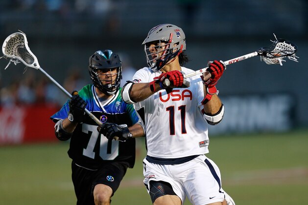 BOSTON, MA - JUNE 26: Steven Denapoli #70 defends against Paul Rabil #11 of Team USA in the fourth quarter during the 2014 MLL All Star Game at Harvard Stadium on June 26, 2014 in Boston, Massachusetts.  (Photo by Jim Rogash/Getty Images)
