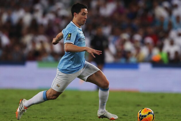 AL AIN, UNITED ARAB EMIRATES - MAY 15: Samir Nasri of Manchester City in action during the friendly match between Al Ain and Manchester City at Hazza bin Zayed Stadium on May 15, 2014 in Al Ain, United Arab Emirates.  (Photo by Francois Nel/Getty Images)