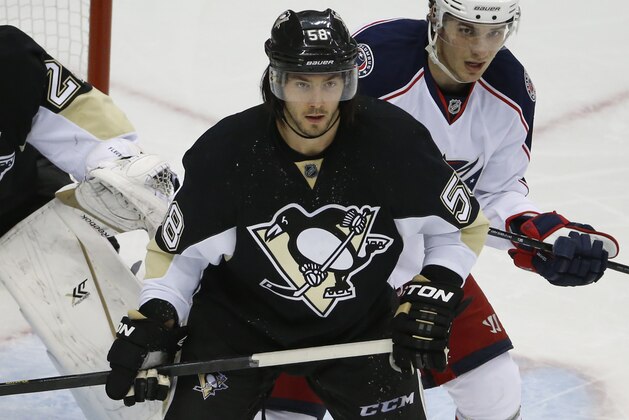 Pittsburgh Penguins defenseman Kris Letang (58) guards the goal crease in the third period of a first-round NHL playoff hockey game against the Columbus Blue Jackets in Pittsburgh Wednesday, April 16, 2014. The Penguins won 4-3. (AP Photo/Gene J. Puskar)