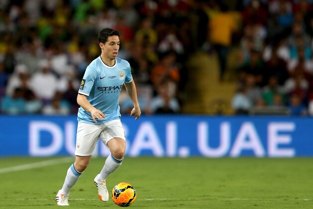 AL AIN, UNITED ARAB EMIRATES - MAY 15:  Samir Nasri of Manchester City in action during the friendly match between Al Ain and Manchester City at Hazza bin Zayed Stadium on May 15, 2014 in Al Ain, United Arab Emirates.  (Photo by Warren Little/Getty Images)
