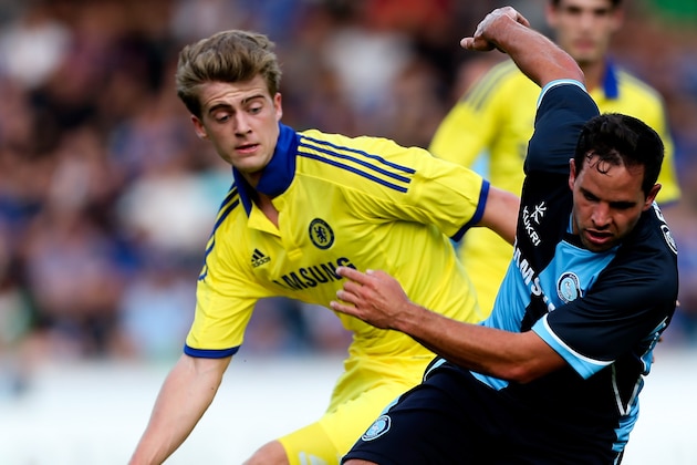 HIGH WYCOMBE, ENGLAND - JULY 16:  Sam Wood of Wycombe holds off the challenge of Marco van Ginkel of Chelsea duing the pre season friendly match between Wycombe Wanderers and Chelsea at Adams Park on July 16, 2014 in High Wycombe, England.  (Photo by Ben Hoskins/Getty Images)